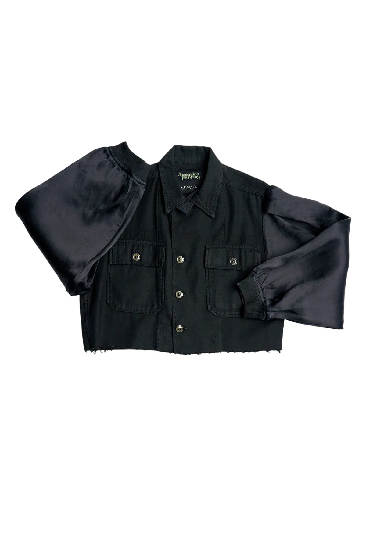 The Ava Cropped Jacket Organza Sleeve by Aquarius Cocktail features a black vintage army style with button front, chest pockets, a raw hem, and shiny silk organza sleeves, shown laid flat on a white background.