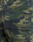 Close-up view of the back pocket from ASKK's Carpenter pants, crafted in Los Angeles with a green and brown camouflage pattern. The fabric showcases stitched and textured details, emphasizing its classic military-style design.