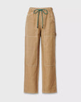 Rag & Bone’s atlas linen pant features a light brown hue, high waist, relaxed wide-leg fit, white stitching, large front pockets, and a green/black drawstring waistband—shown on a plain white background.