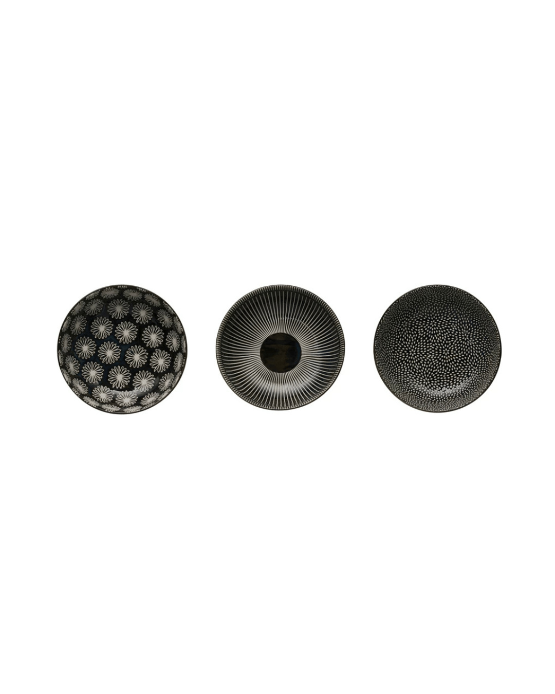 A trio of Creative Co-op decorative stoneware bowls, showcasing intricate floral, concentric, and speckled motifs in black and white patterns, are arranged against a white background.