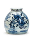 The Blue White Ginger Jar by Two's Company is a round, white porcelain jar with a short neck, featuring traditional blue floral and leaf designs.