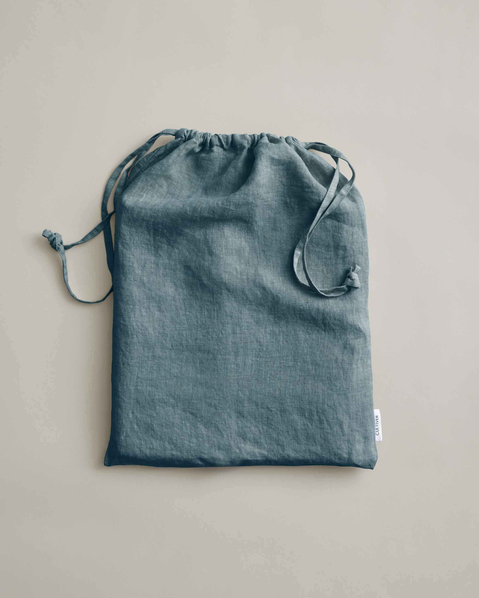 Linen duvet cover in neutral beige by Cultiver Goods, OEKO-TEX certified, displayed flat on a light surface.