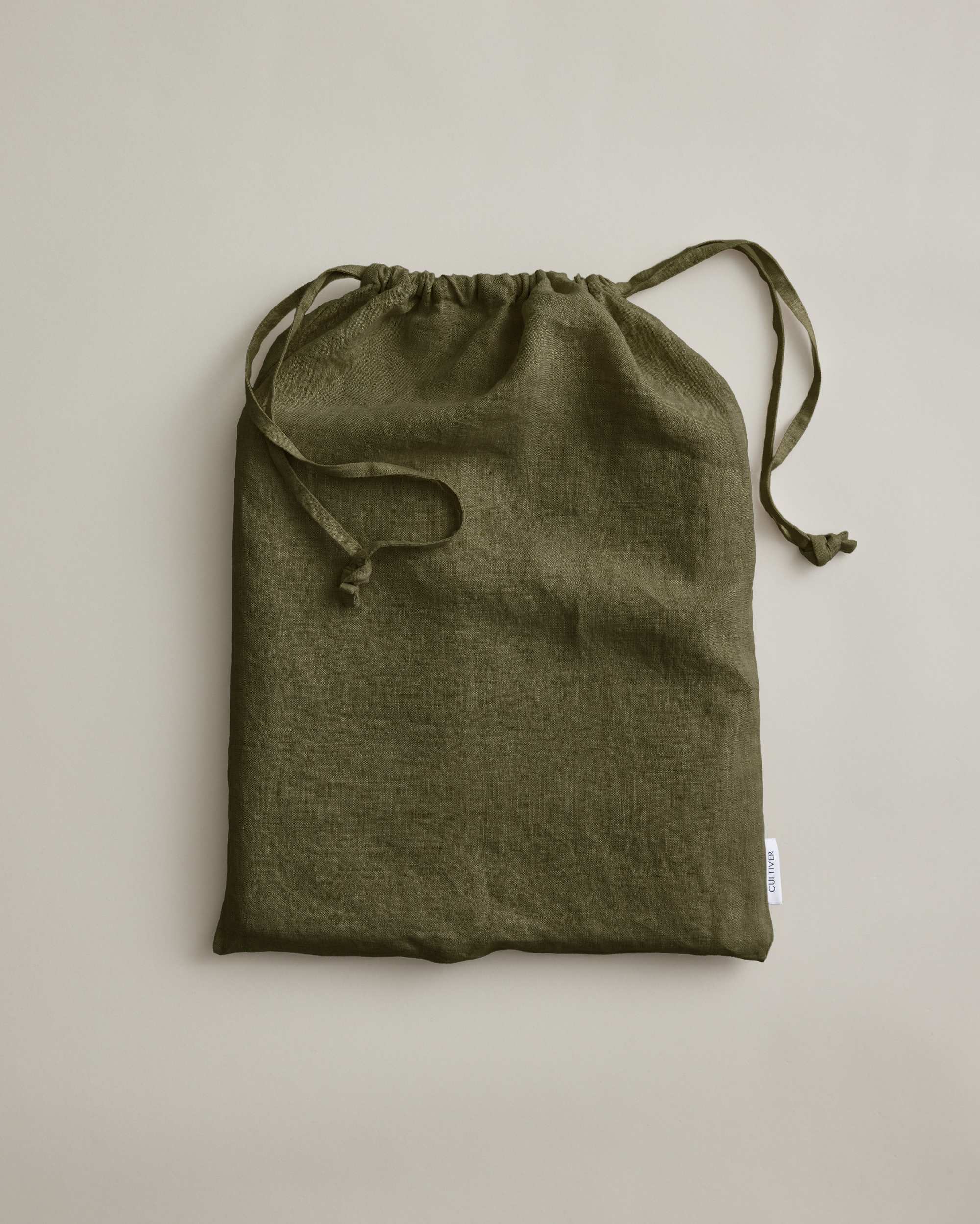 Olive green linen duvet cover by Cultiver Goods, European flax, displayed on a neutral background.