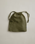 Olive green linen pillowcases by Cultiver Goods, set of 2, displayed on a light beige background.
