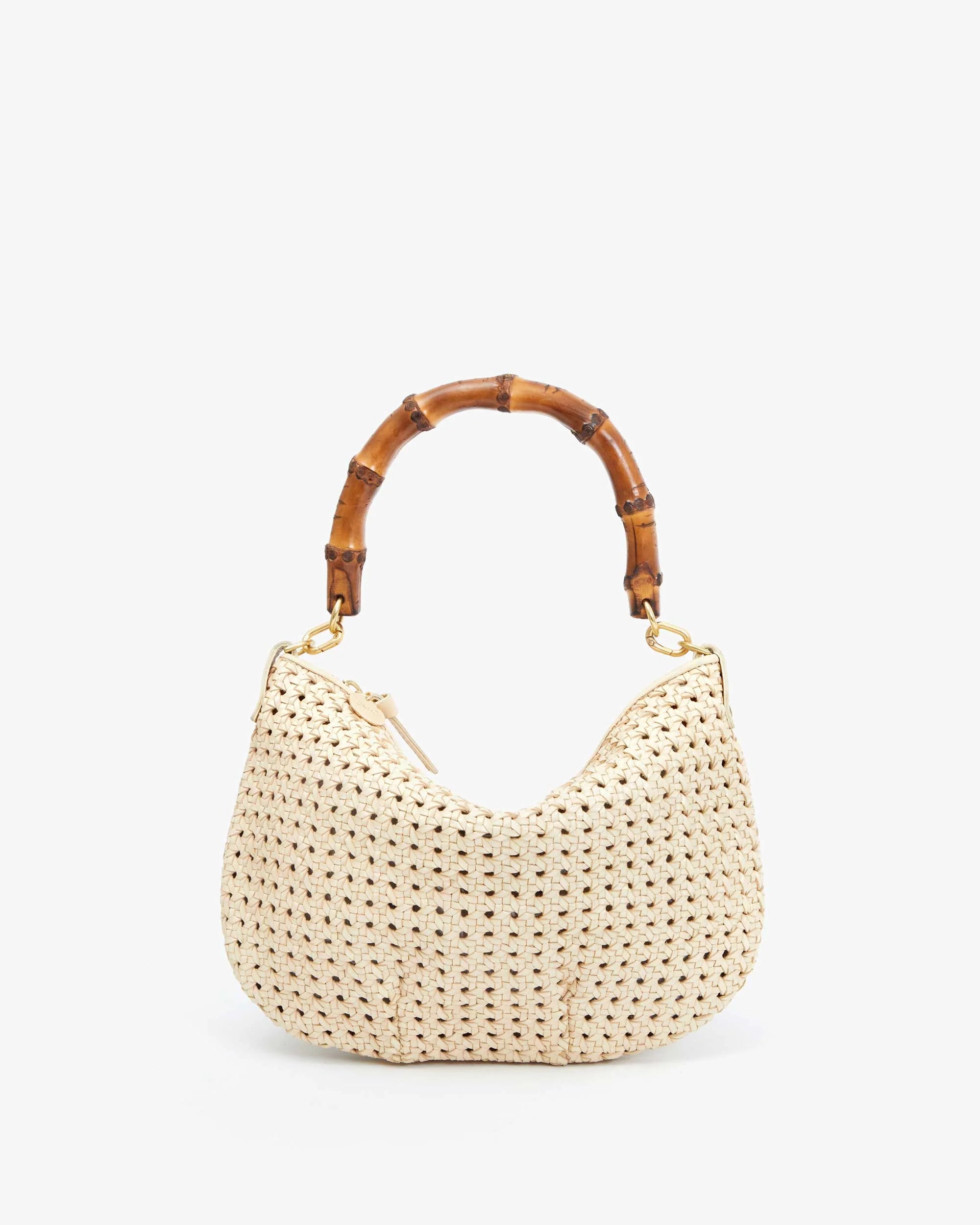 The Clare Vivier Top Handle is a small, woven cream handbag with a textured surface, bamboo top handle strap, and brass spring links, all set against a plain white background.