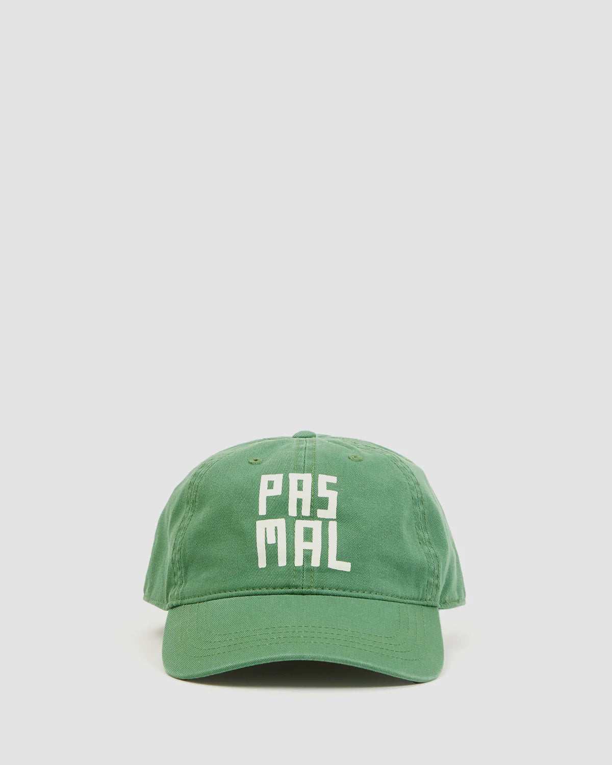 The Clare Vivier Baseball Hat PasMal is a green cotton cap with "PAS MAL" in bold white letters on the front, shown against a plain light background. It features an adjustable strap for a comfortable fit.