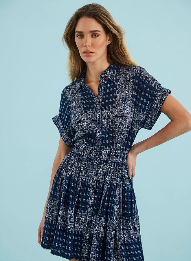 Blue Howard Dress by Hunter Bell NYC, styled on model with hand on hip, light blue background.