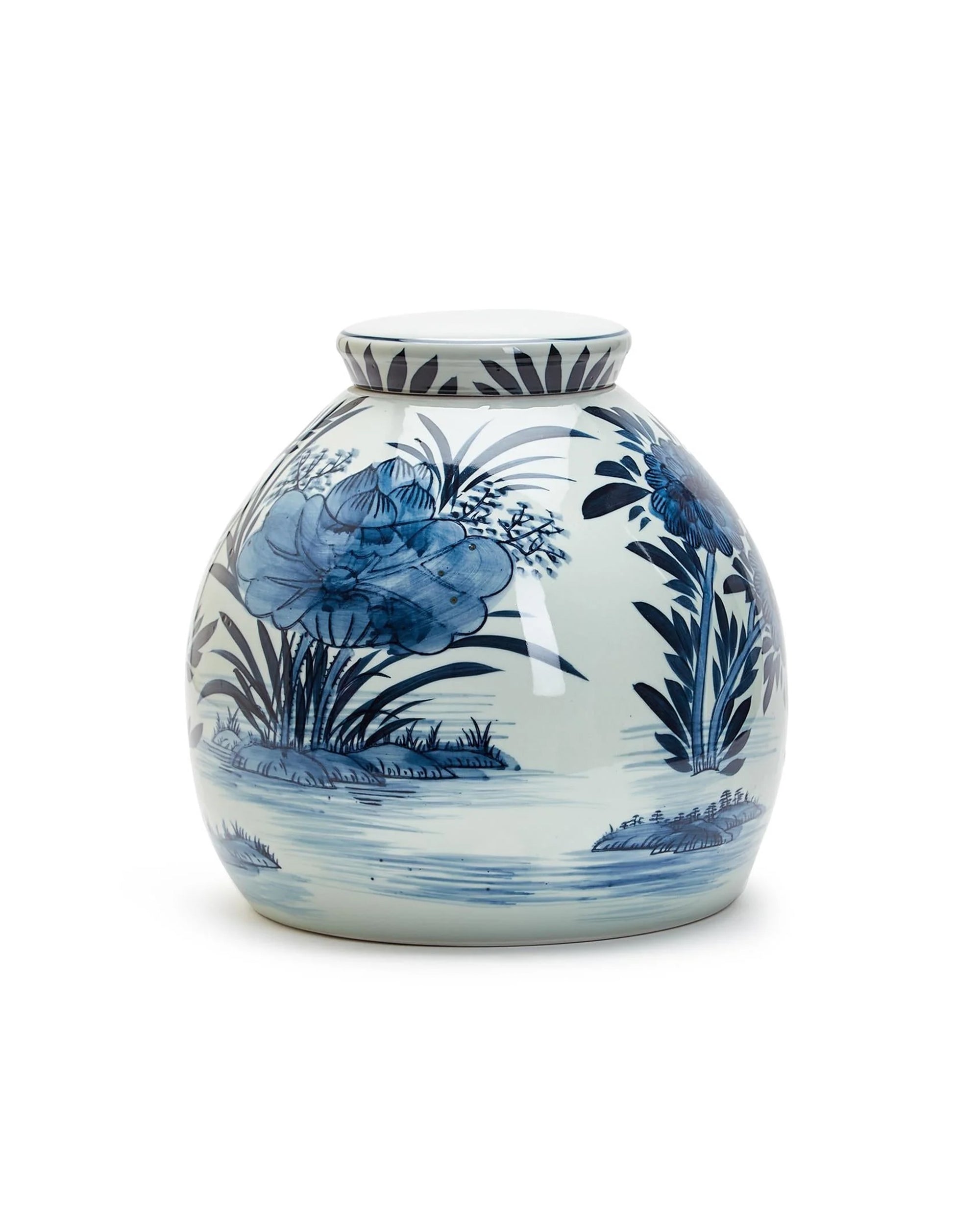 The BLF164 Blue White Ginger Jar by Two's Company is a round, white ceramic jar with a narrow neck, featuring blue floral and leaf patterns in traditional water and plant motifs.