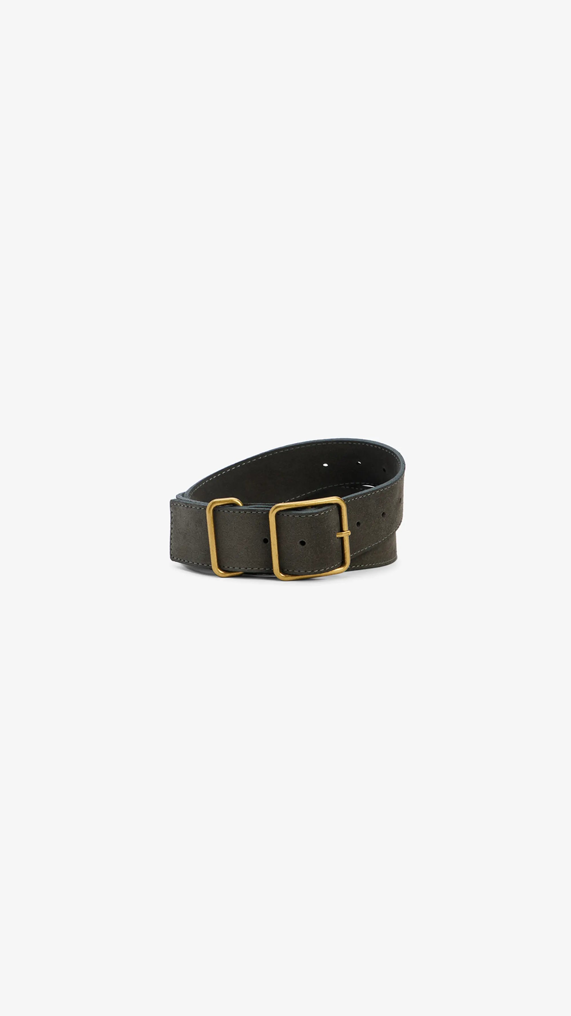 The Bowe Belt by Janessa Leone features dark brown regenerative leather and a rectangular gold buckle, coiled and showcased on a plain white background.