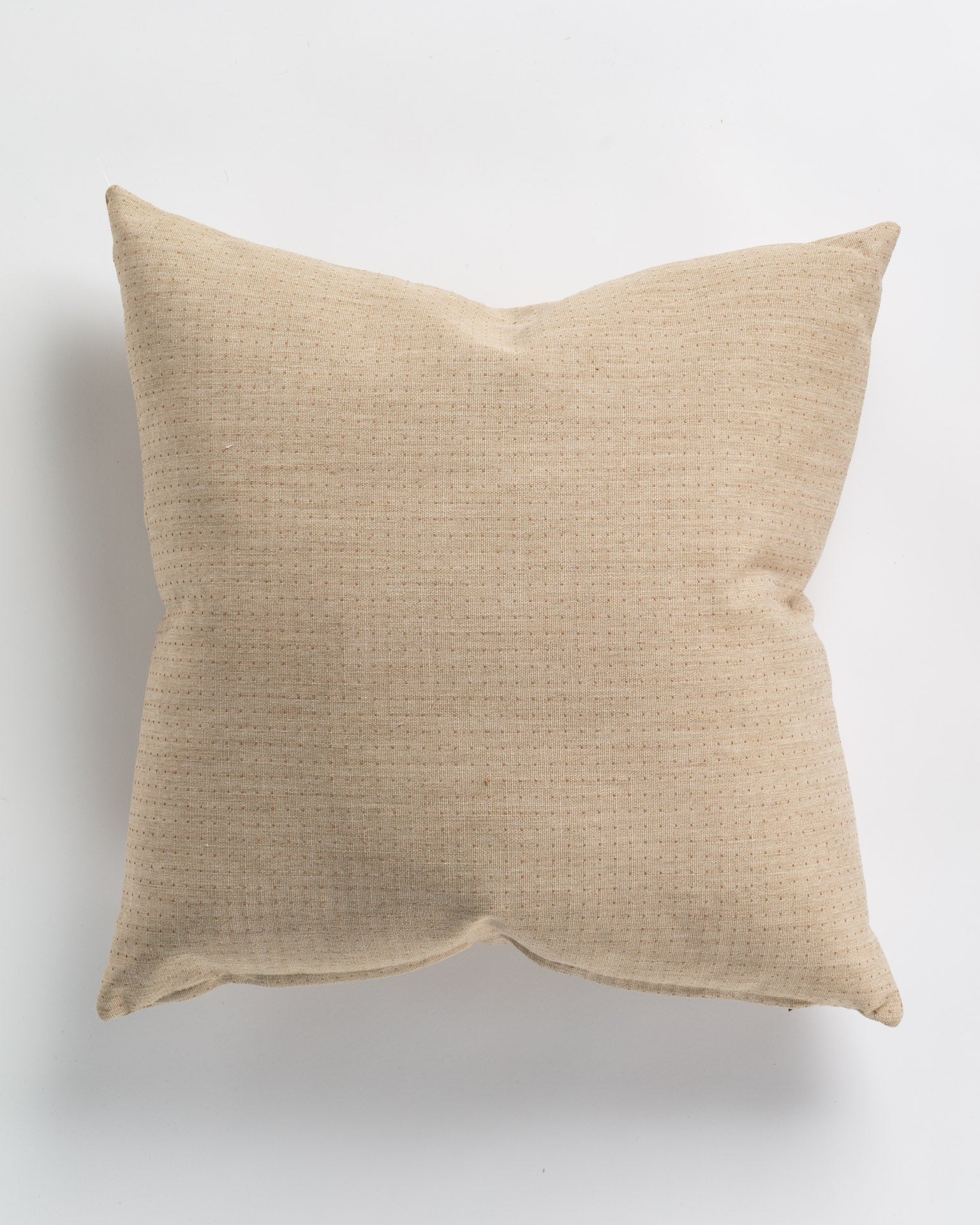 A square beige cushion with a subtle textured pattern is shown on a plain white background. The 26x26" Happy Dot Blush Pillow appears soft and plush with a clean, simple design, perfect as a Gabby accent piece.