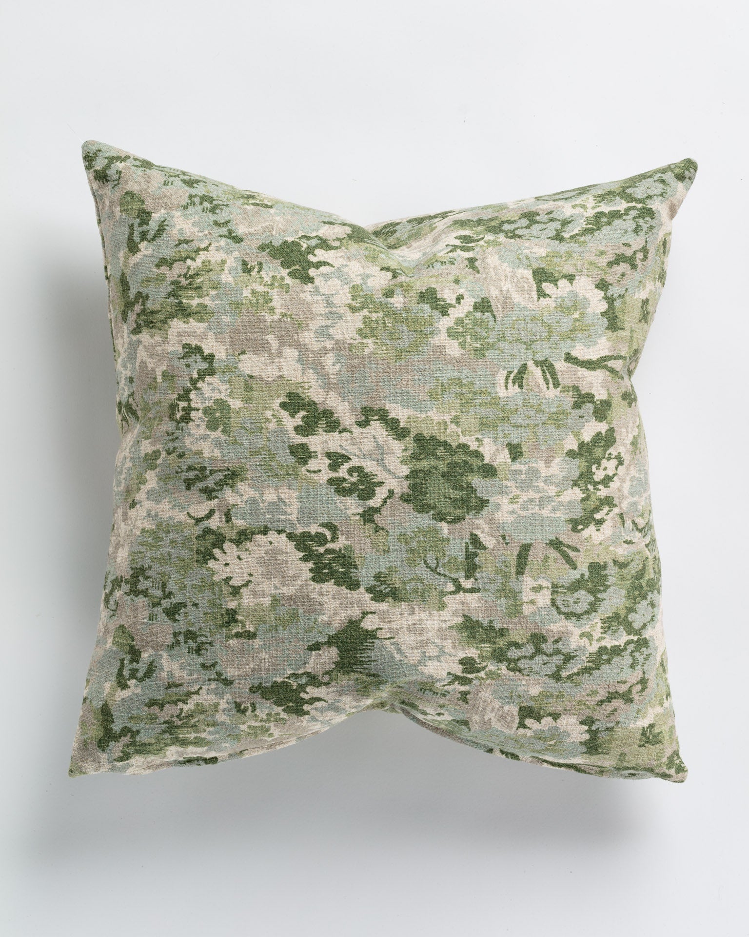 Gabby's Imperial Ivy Pillow 26x26, with a faded green floral pattern on a neutral background, photographed against a white surface in Scottsdale, Arizona.
