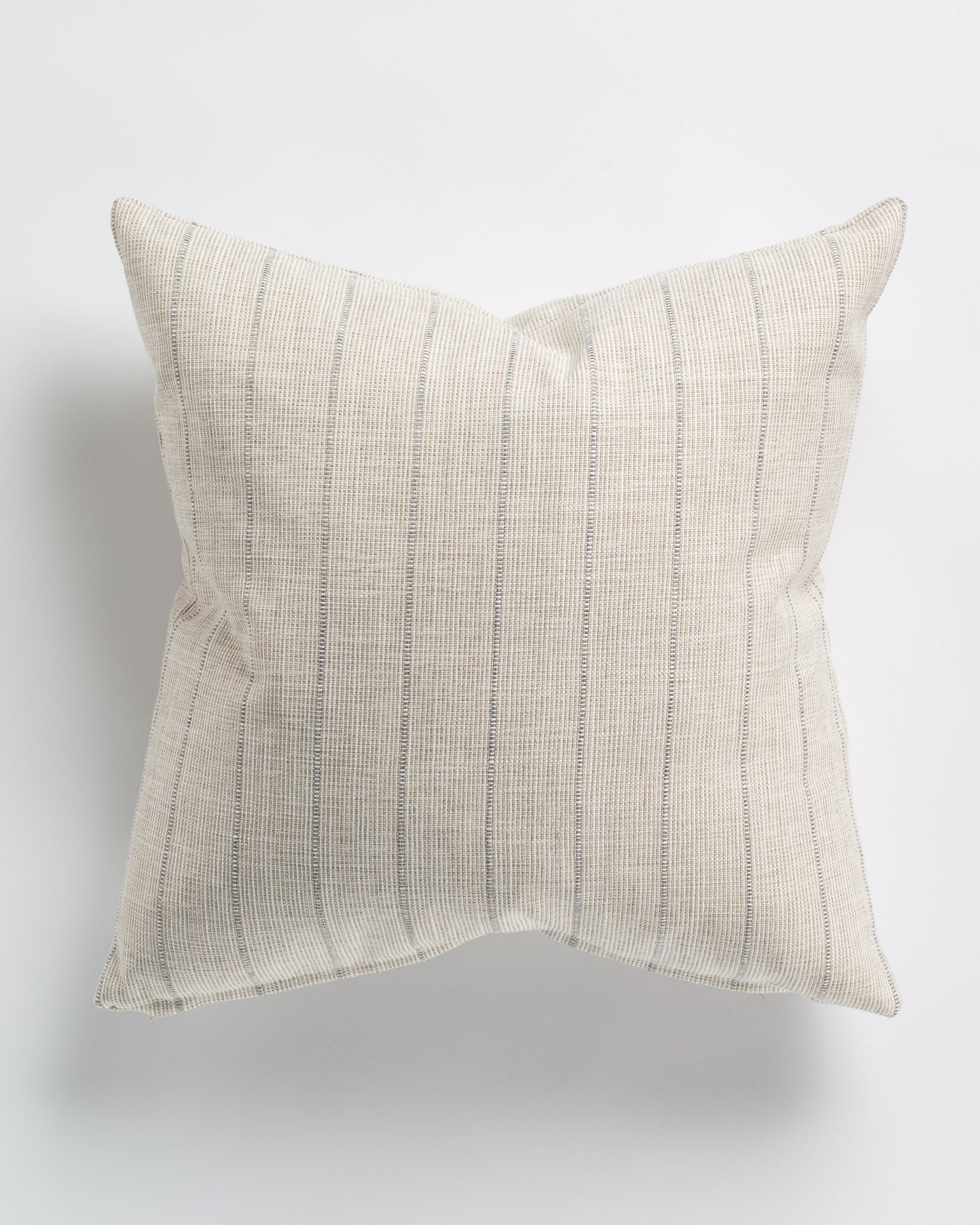 A square Reed Stripe Silver Pillow 26x26 from Gabby, with subtle vertical white stripes, set against a plain white background, epitomizes Arizona-style décor.