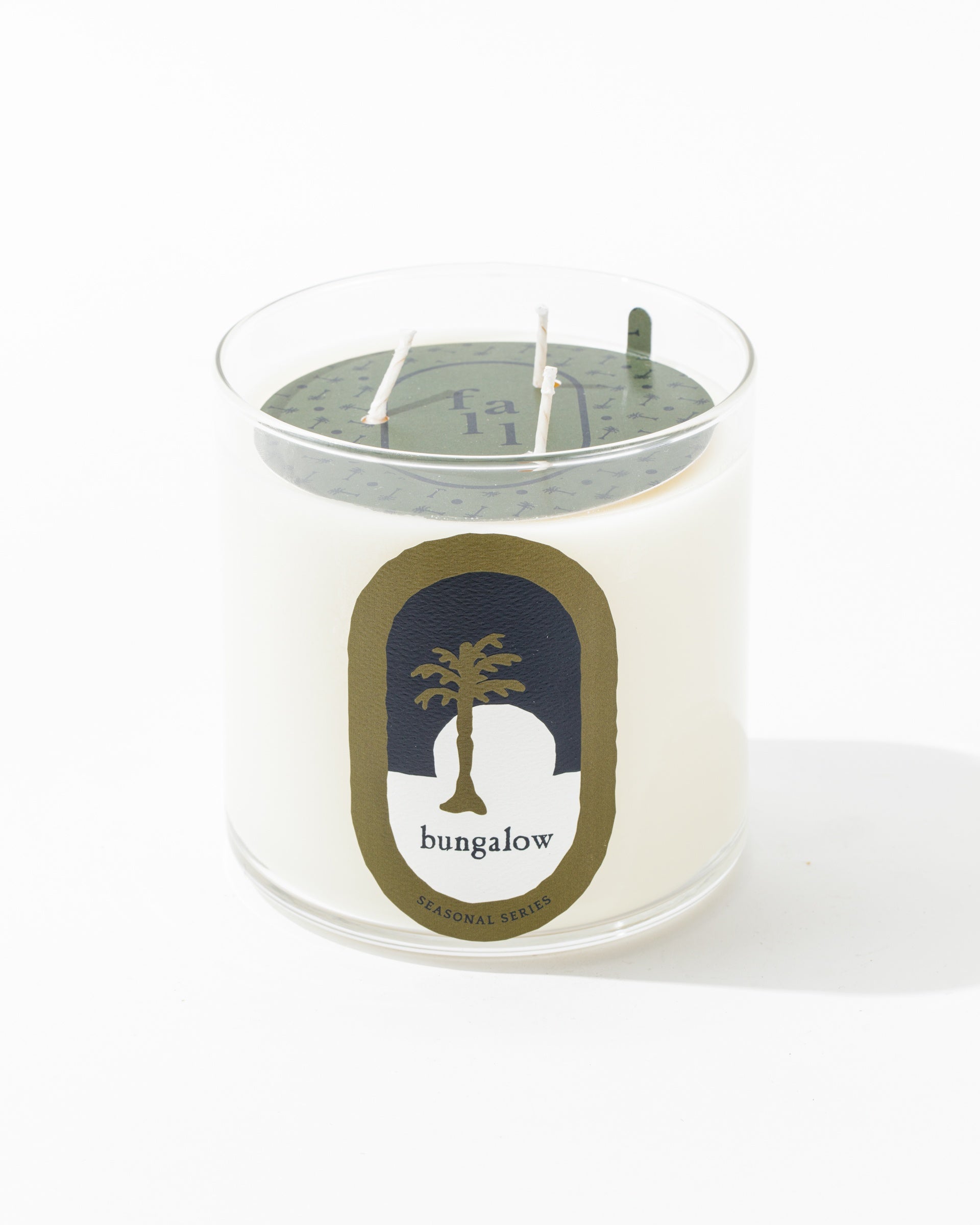 A Mame Private Label NEW Fall 33oz glass jar candle with white wax, featuring a label that reads "bungalow" and displays a palm tree graphic. The candle has three wicks and is part of the seasonal series collection.