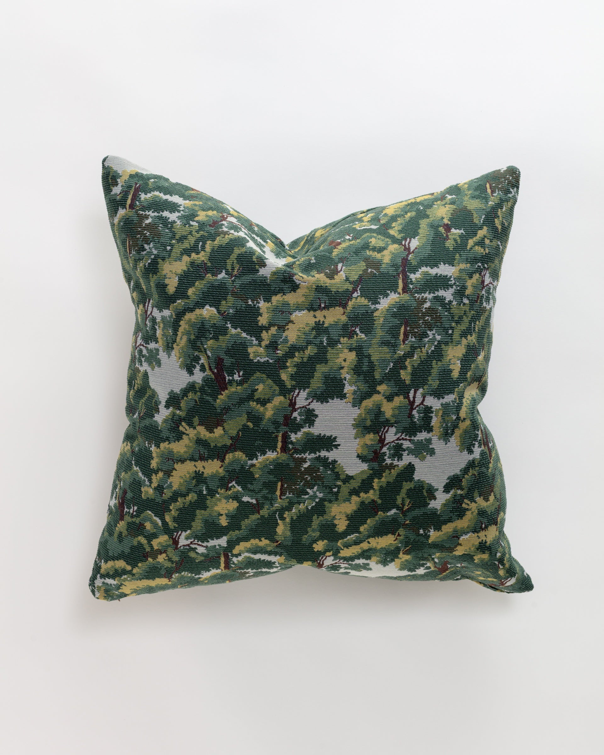 The Norwalk North Oak Pillow features a forest pattern of green trees on a gray background, set against a plain white backdrop. This luxurious square euro pillow includes an insert for a soft and plush feel.