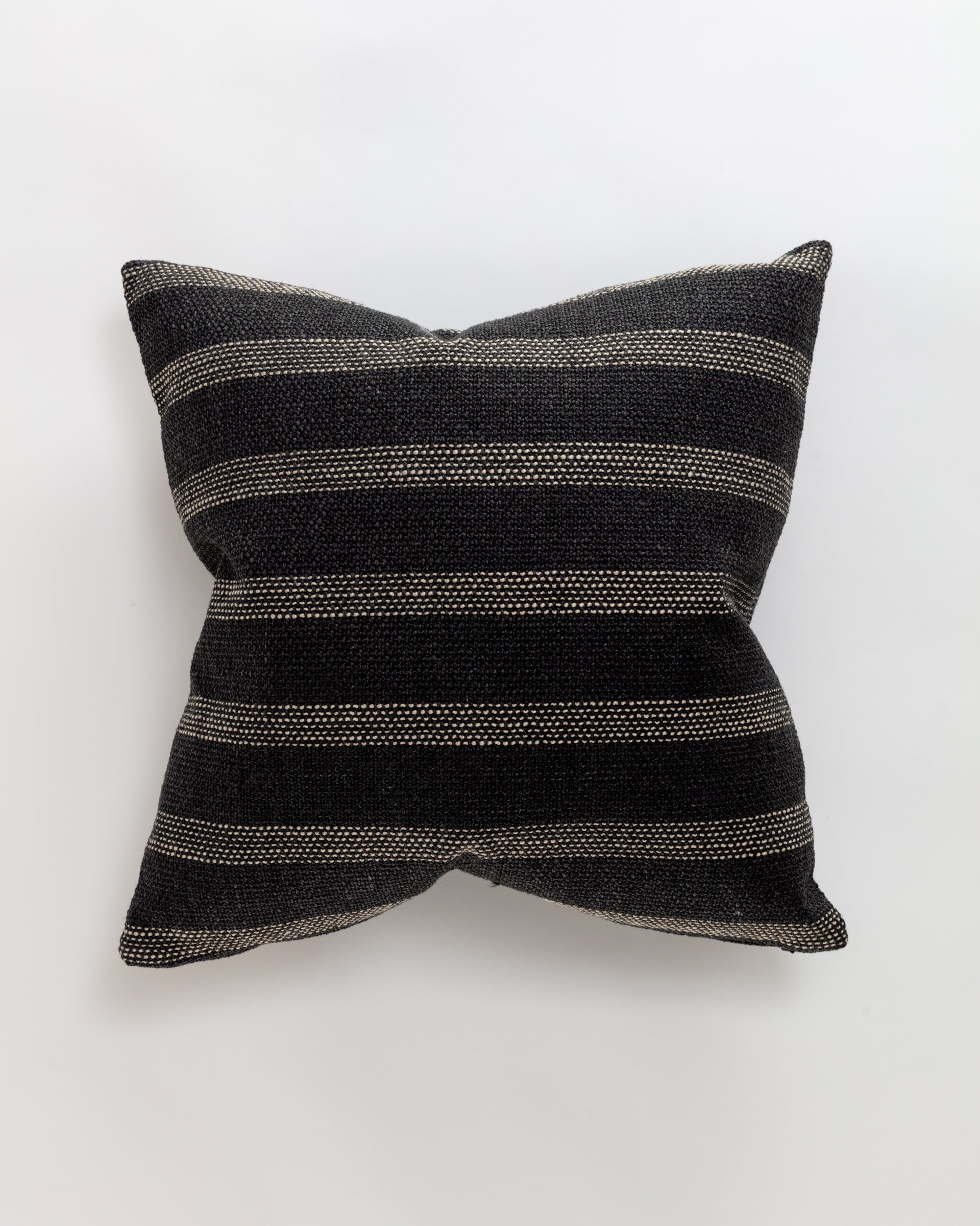 The Norwalk Channel Pillow is a luxurious throw with dark gray and black horizontal stripes on a light background. The woven fabric showcases elegant, evenly spaced lines, complemented by a plush down insert.