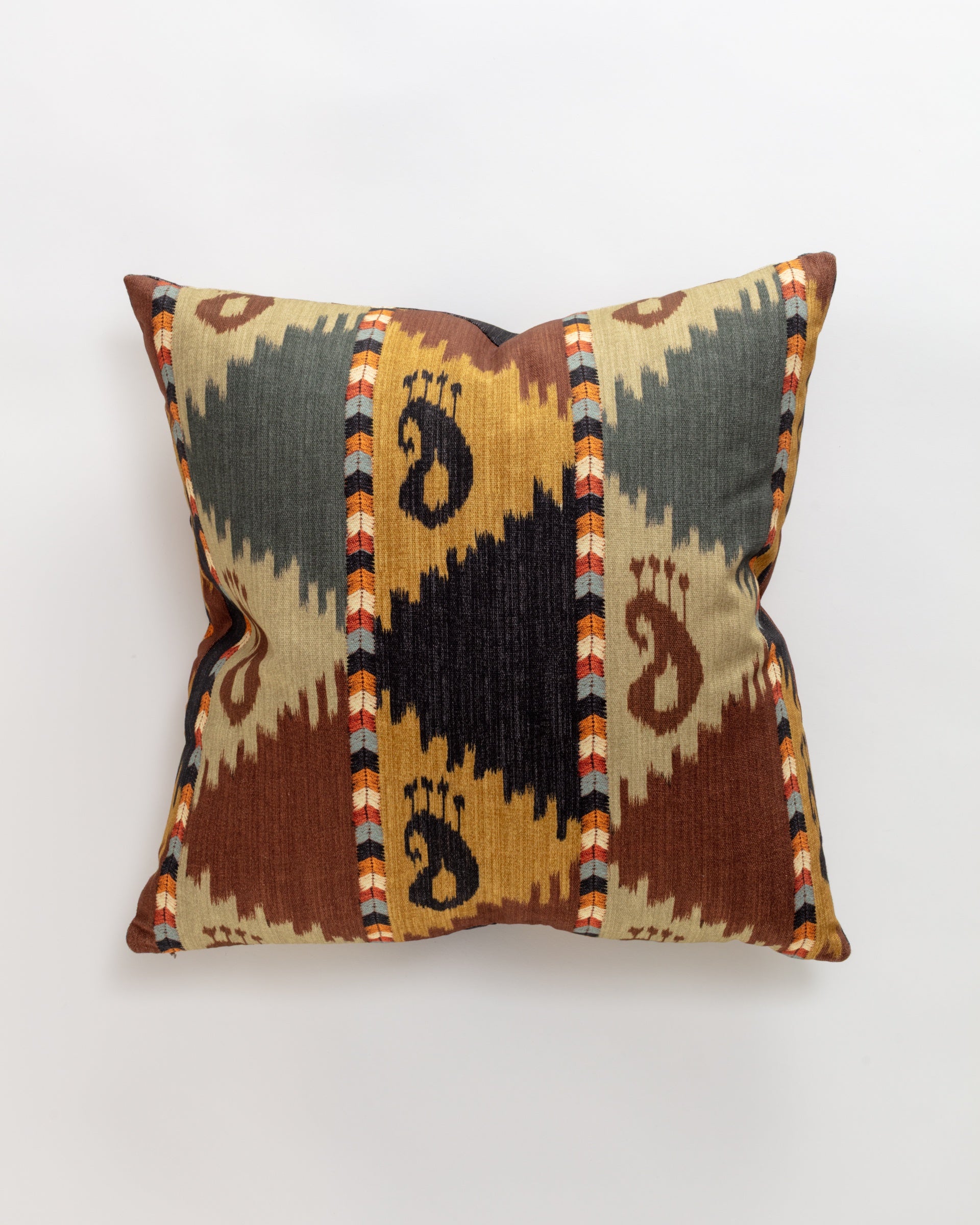 The Norwalk Tribal Ikat Pillow is ultra-luxurious, with a geometric pattern of large triangles in brown, green, and mustard. It features vibrant accents in orange, blue, and cream and black paisley motifs at the center. Comes with a relaxing down pillow insert for ultimate comfort.