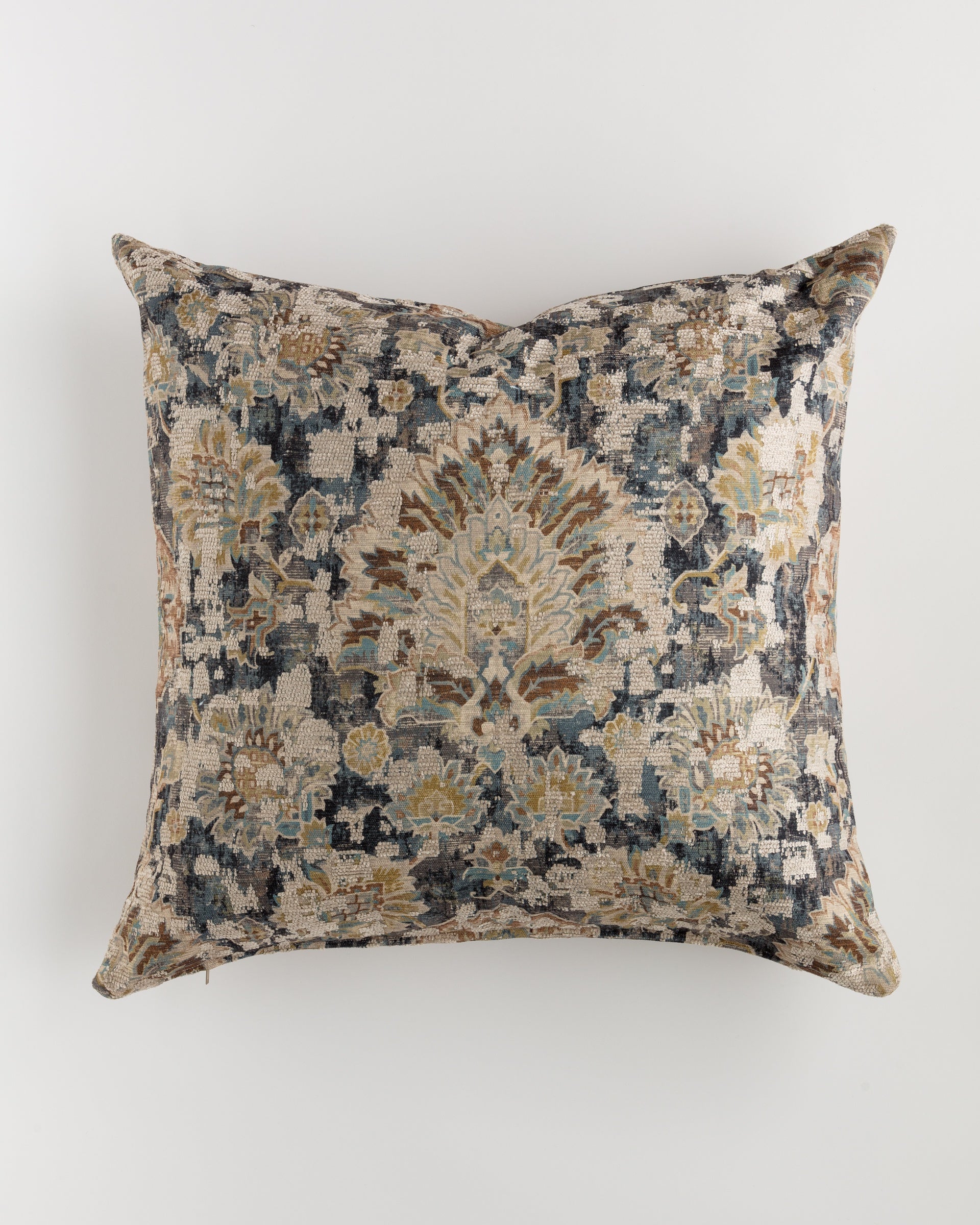 The Custom 3 Pillow 28x28 by Pindler is a square decorative pillow featuring an intricate pattern with floral and geometric designs in shades of blue, beige, and brown. Ideal for layering on your bed or sofa, this ultra-luxurious euro pillow boasts textured fabric and an antique, vintage aesthetic against a plain white background.