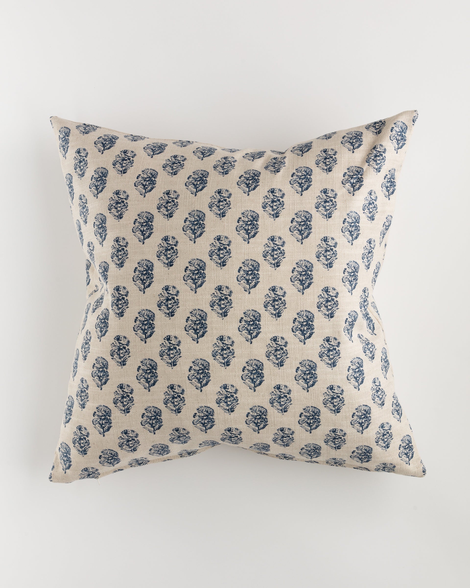 A luxurious Pindler Custom 1 Pillow 28x28, featuring a beige background adorned with a repeating pattern of blue floral designs, complete with a plush pillow insert, is showcased against a plain white backdrop.