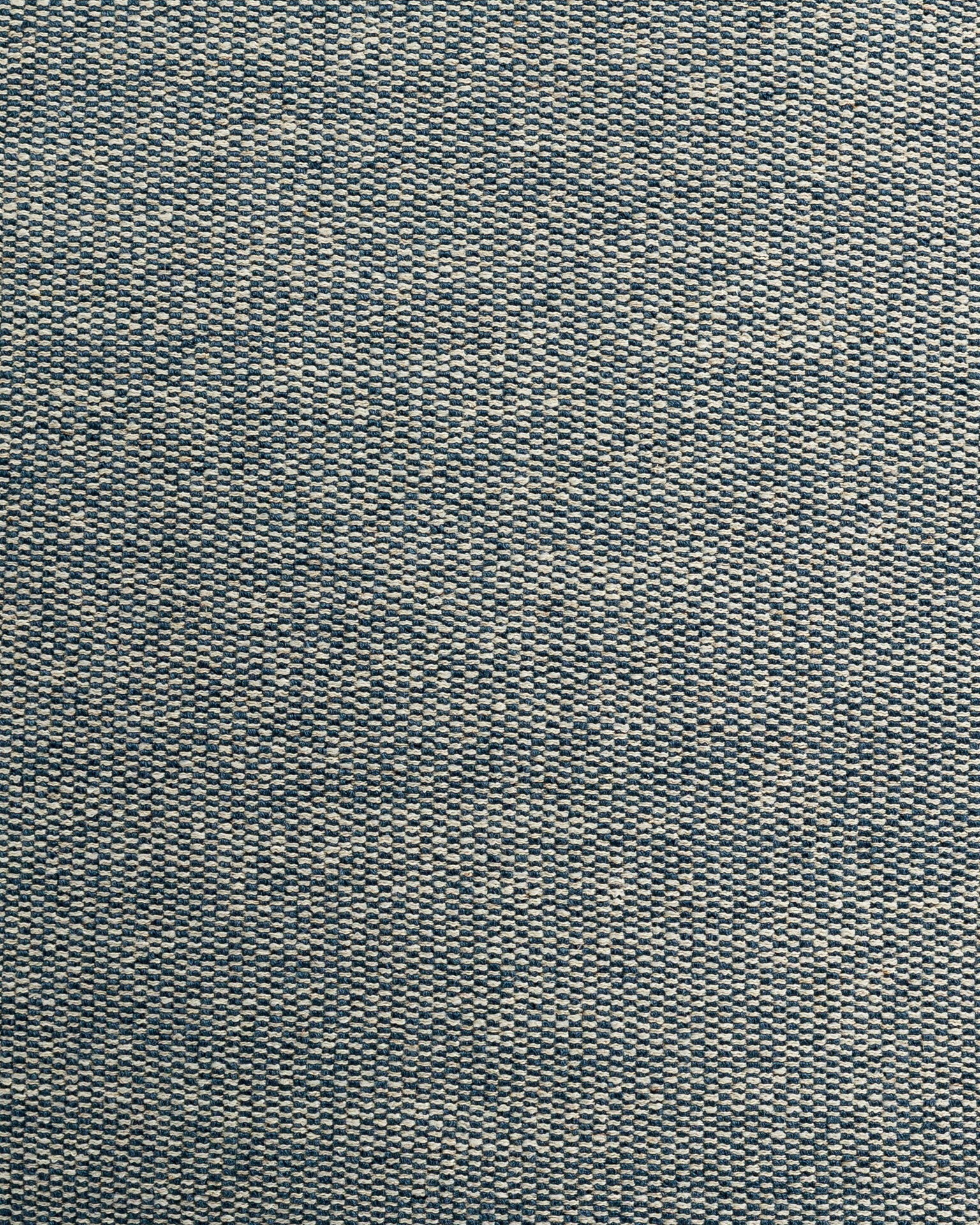 Close-up texture of a blue denim fabric showcasing detailed weaving patterns with light and dark blue threads in Scottsdale, Arizona.