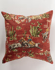 The Custom 2 Pillow 28x28 by Pindler adds a touch of luxury to your decor with its red background featuring a vintage Western-themed print. This custom-made square pillow showcases cowboys on horses, cattle, ropes, and cacti, embodying a rustic old-west aesthetic that brings charm to any space.