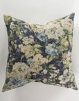 Introducing the Custom 2 Pillow 28x28 by Pindler, a luxurious square pillow adorned with a floral pattern of blue, white, and green flowers and leaves on a dark backdrop. This exquisite piece is perfect for pairing with custom-made euro pillows to add an elegant touch to your decor.