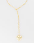 A Lucky Star Bubble Heart Necklace with a heart-shaped pendant hangs against a plain white background. The necklace features an elongated drop that connects the medium pendant to the 33" chain. The design is simple and elegant.