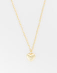 A delicate, gold chain necklace with a medium, heart-shaped pendant hanging at the center. The 33" chain, named the Bubble Heart Necklace by Lucky Star, is composed of medium-sized, oval links, and the pendant has a smooth, shiny finish. The background is plain white.