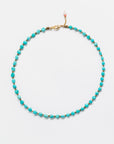 Designs By Raya Turquoise Bead Necklace with gold accents and an Arizona-style clasp, displayed against a white background.