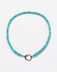 A beautiful Designs By Raya Arizona turquoise bead necklace displayed on a white background. The necklace features a circular silver clasp at its center.