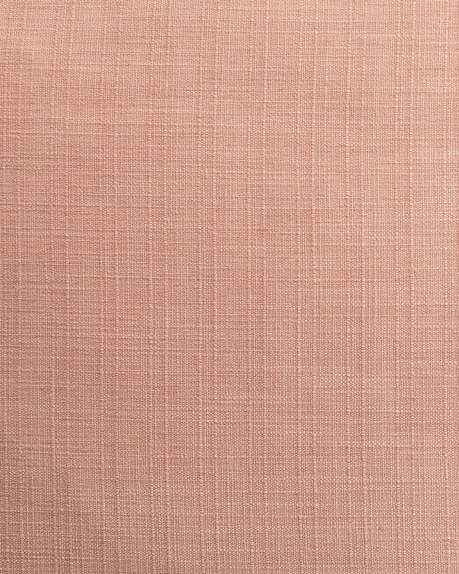 Close-up texture of a light pink fabric with a subtle, linear weave pattern, reminiscent of a bungalow in Scottsdale, Arizona featuring the Splendor Nude Pillow 26x26 by Gabby.