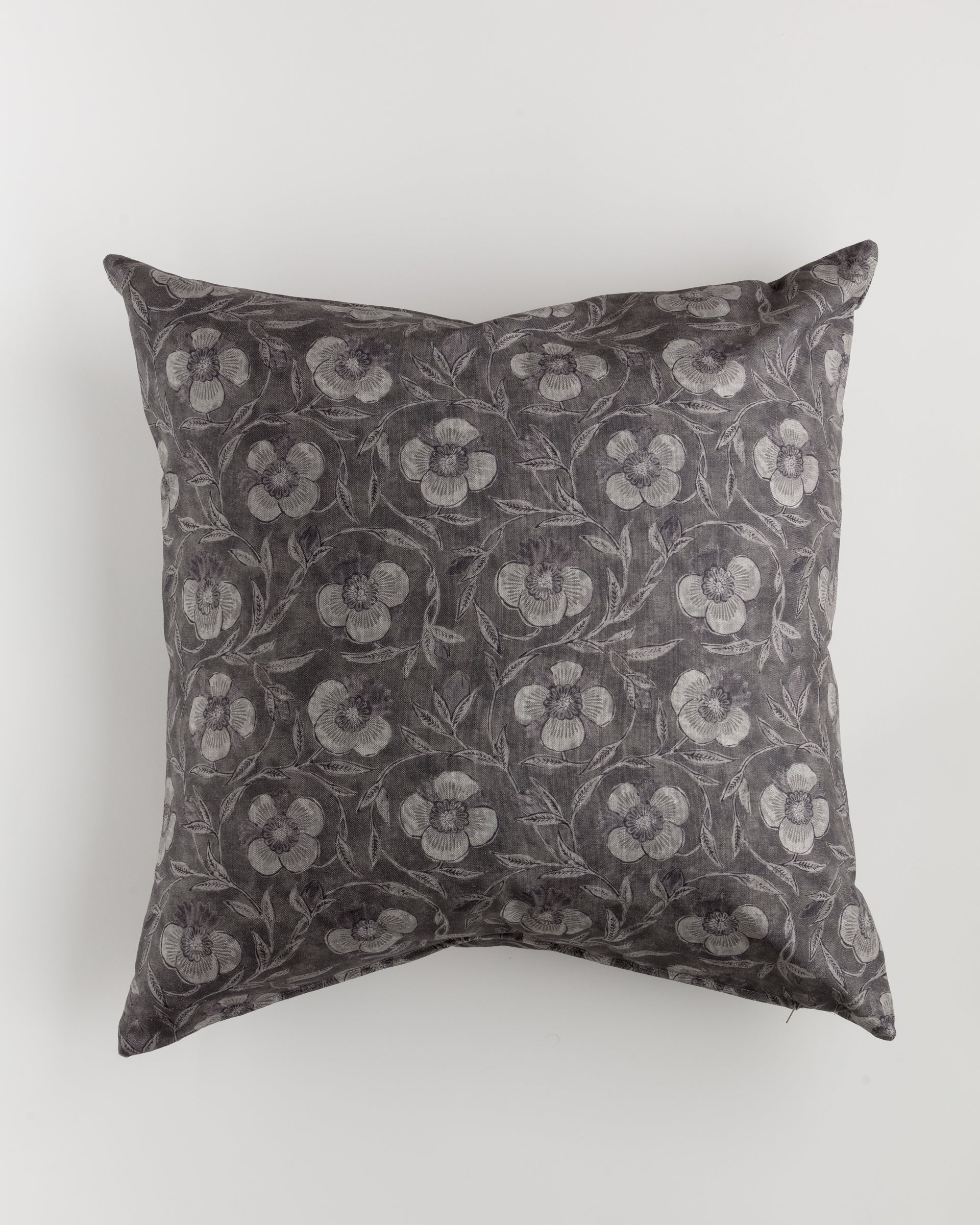 Introducing the Custom 2 Pillow 28x28 by Pindler, a square decorative pillow adorned with a dark gray floral pattern on a lighter gray background. The pillow showcases visible creases that highlight its softness and plush texture. This exclusive piece by Bungalow's minimalist design adds a touch of elegance to any setting.