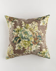 The Custom 1 Pillow 28x28 by Pindler is a square throw pillow showcasing a vintage floral pattern in shades of green, blue, and brown against a muted taupe background. This pillow provides extra comfort and features a slightly worn, rustic look that enhances its luxurious vintage charm.