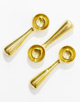 Three shiny, gold-colored Brass Dessert Scoops of varying sizes from Sir/Madam are arranged on a white background. Crafted from 100% food-safe brass, these scoops feature a sleek, modern design with short, thick handles and rounded bowls. Their reflective surfaces create bright highlights, making them an elegant addition to any kitchenalia collection.