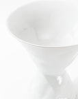 A close-up view of the sophisticated Catchall Bowl No. 979 by Montes Doggett, showcasing its elegant white ceramic design with a smooth and glossy surface that reflects light softly against a white background.