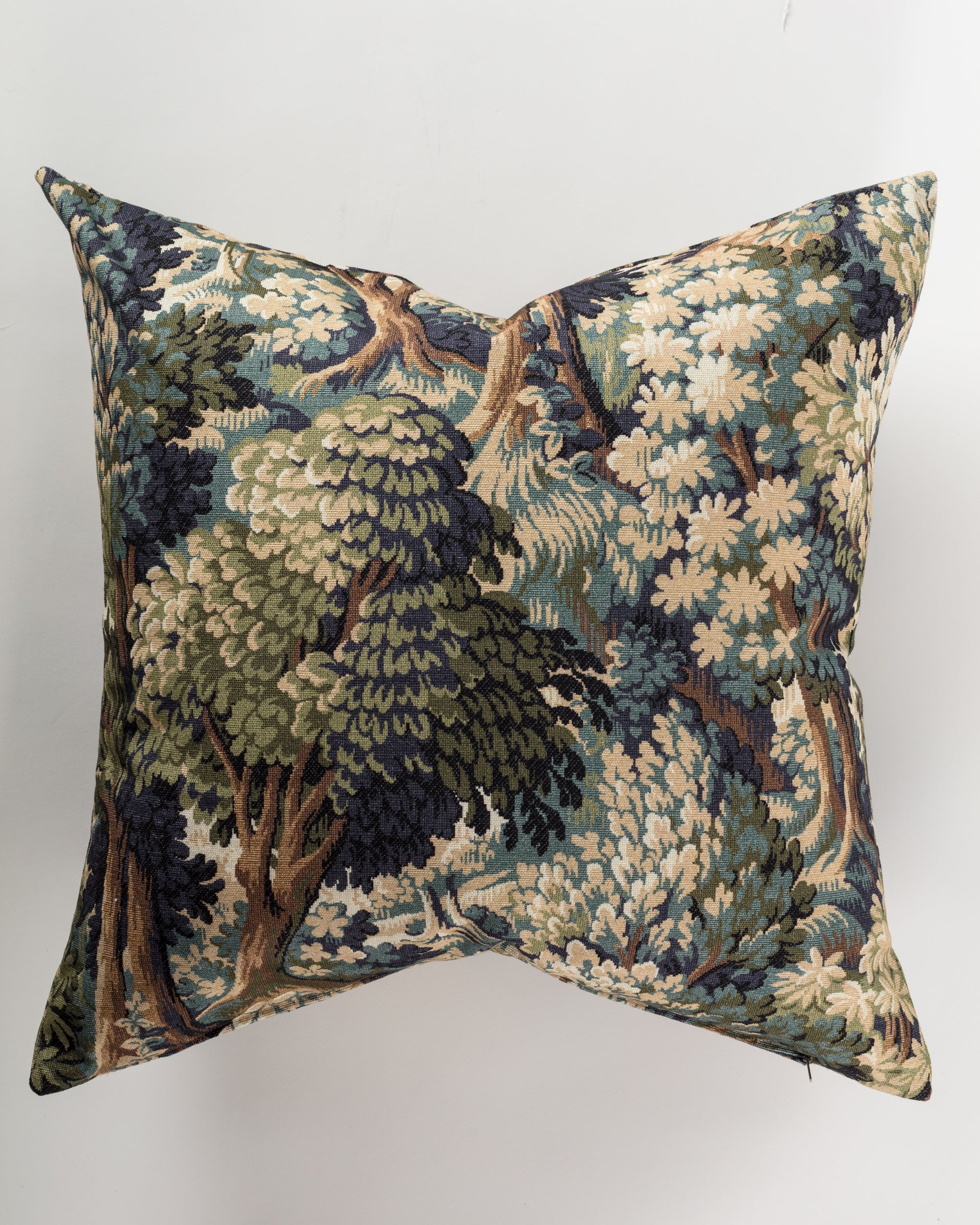 Introducing the Custom 3 Pillow 28x28 by Pindler, a luxurious euro pillow adorned with a detailed tapestry of a dense, leafy green forest. This design combines shades of blue, beige, and brown featuring various trees and foliage set against a neutral background to provide both comfort and style.