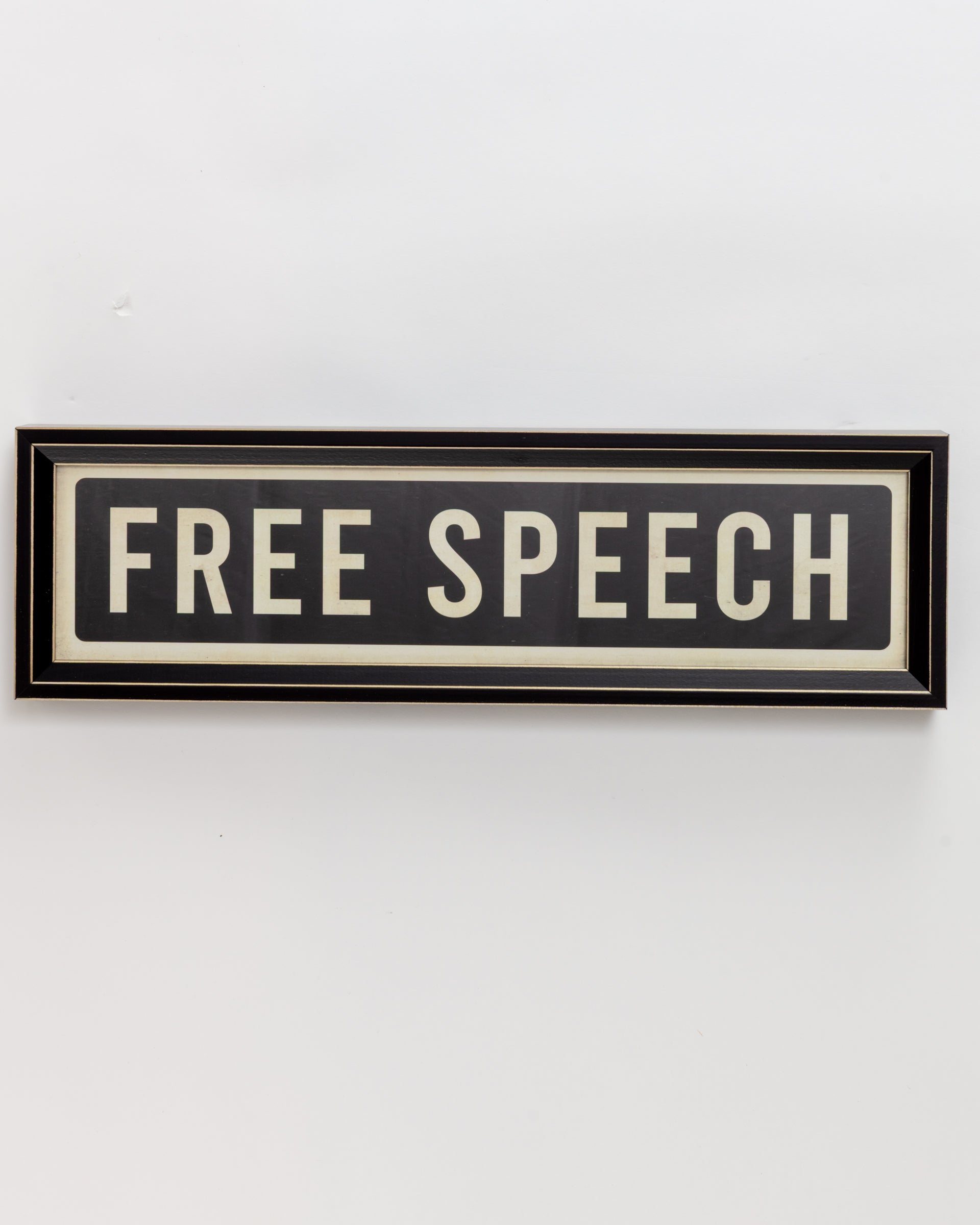 The Small Sign In Black by Spicher And Company features a dark background with bold white letters spelling "FREE SPEECH" in a black frame, capturing the essence of custom skateboard deck statements.