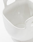 Close-up image of Montes Doggett's 4994 Bowl no. 994, a high-fired ceramic container with a smooth, glossy finish. This sculptural statement piece features two large, curved handles on opposite sides and a wide, open mouth. Handmade in Peru, the white background highlights the container's intricate details clearly.