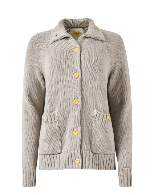 The Joy Sweater Coat by Kerri Rosenthal is a beige knit cardigan featuring yellow buttons, front pockets, and a collar. It includes ribbed cuffs and hem for a cozy and stylish look, while its chunky cotton material boasts subtle multicolor embroidery that adds an artistic flair to the plain white background.