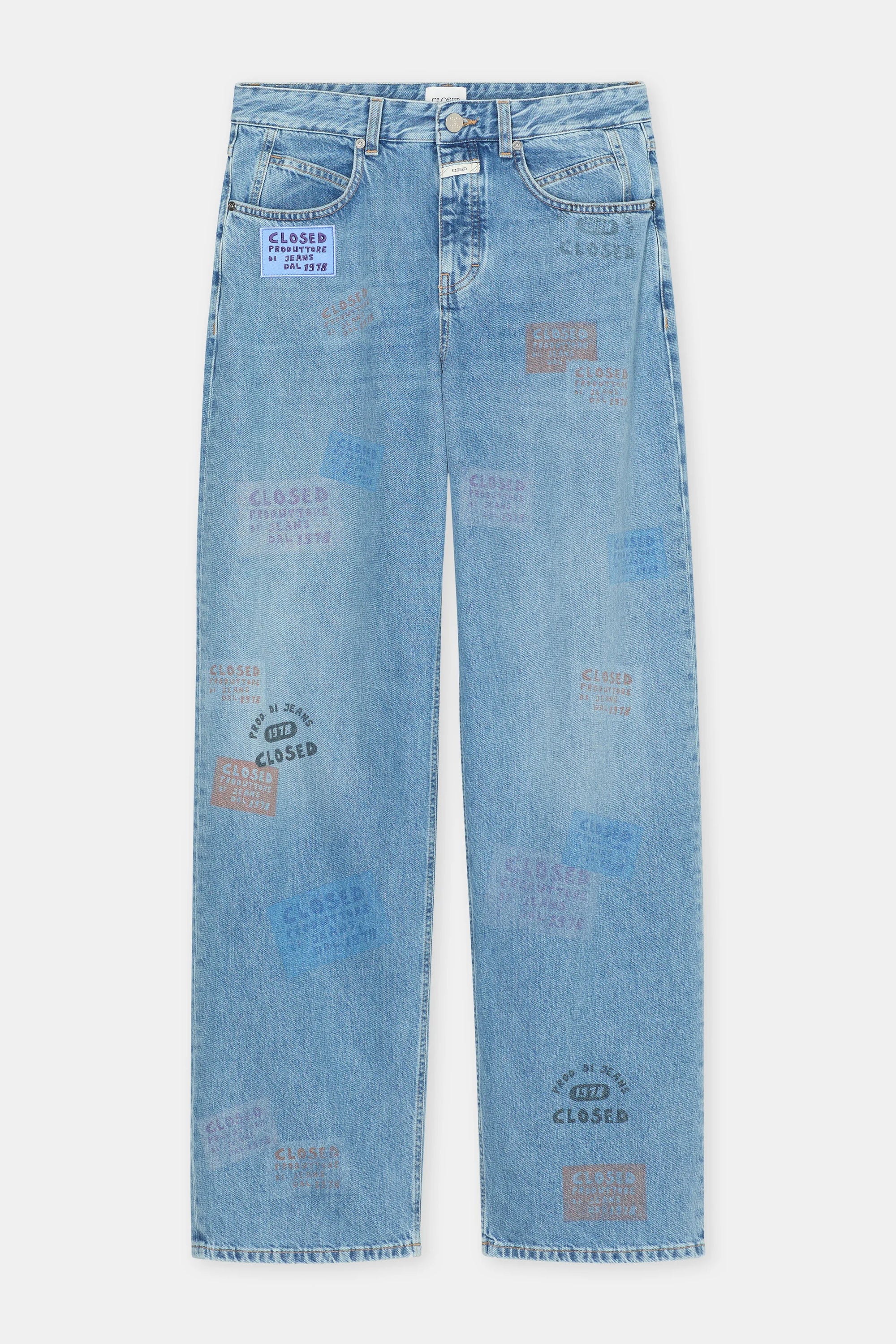 The Nikka Denim by CLOSED offers a relaxed fit in light blue eco-conscious denim, detailed with colorful "CLOSED" stamps, text designs, front pockets, belt loops, and a button closure.