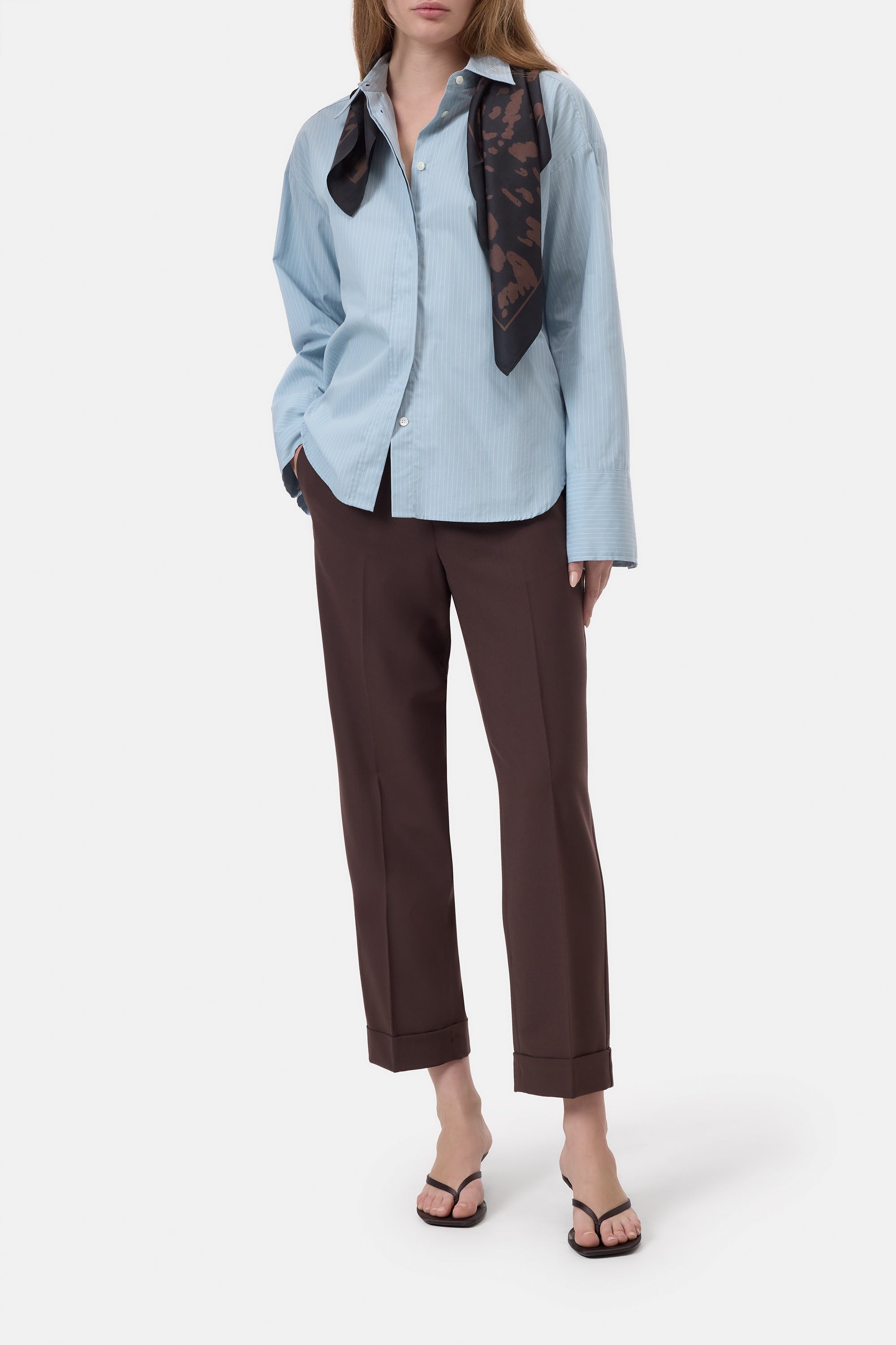 Light blue CLOSED Souki shirt and mid-rise wool-blend trousers styled with a black scarf and sandals on white background.