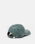 The CLOSED Cap in teal cotton is shown from the back, highlighting its adjustable strap with a metal buckle and washed finish for casual comfort against a white background.