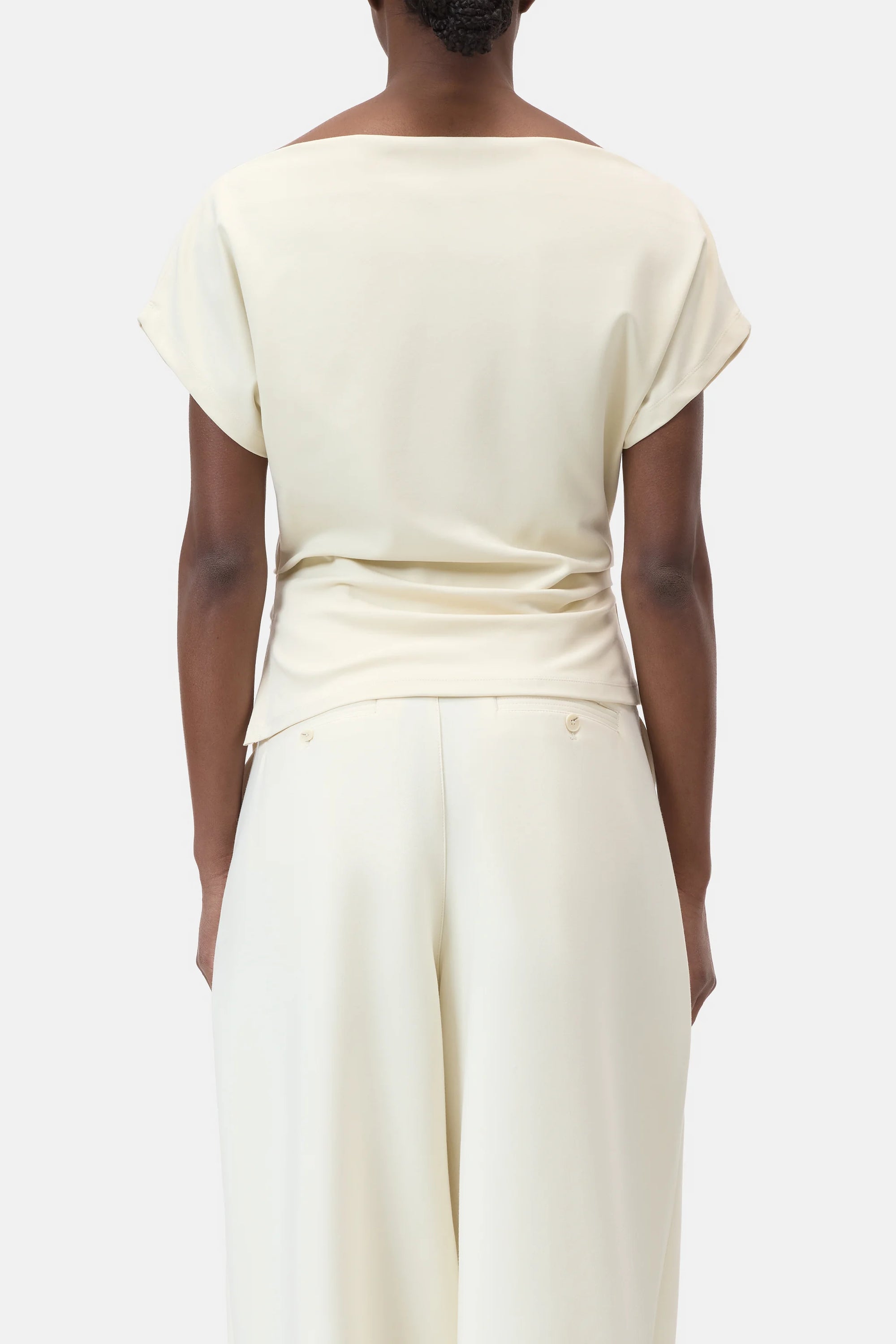 A person is seen from the back wearing CLOSED's Off Shoulder Top in light cream with short sleeves and matching wide-leg pants, set against a plain white background.