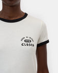 A person wears the CLOSED Slim T-Shirt, a slim-fit style with black trim and "PROD. DI JEANS 1978 CLOSED" on the left chest, showing only their lower face and upper torso—a classic design from CLOSED.