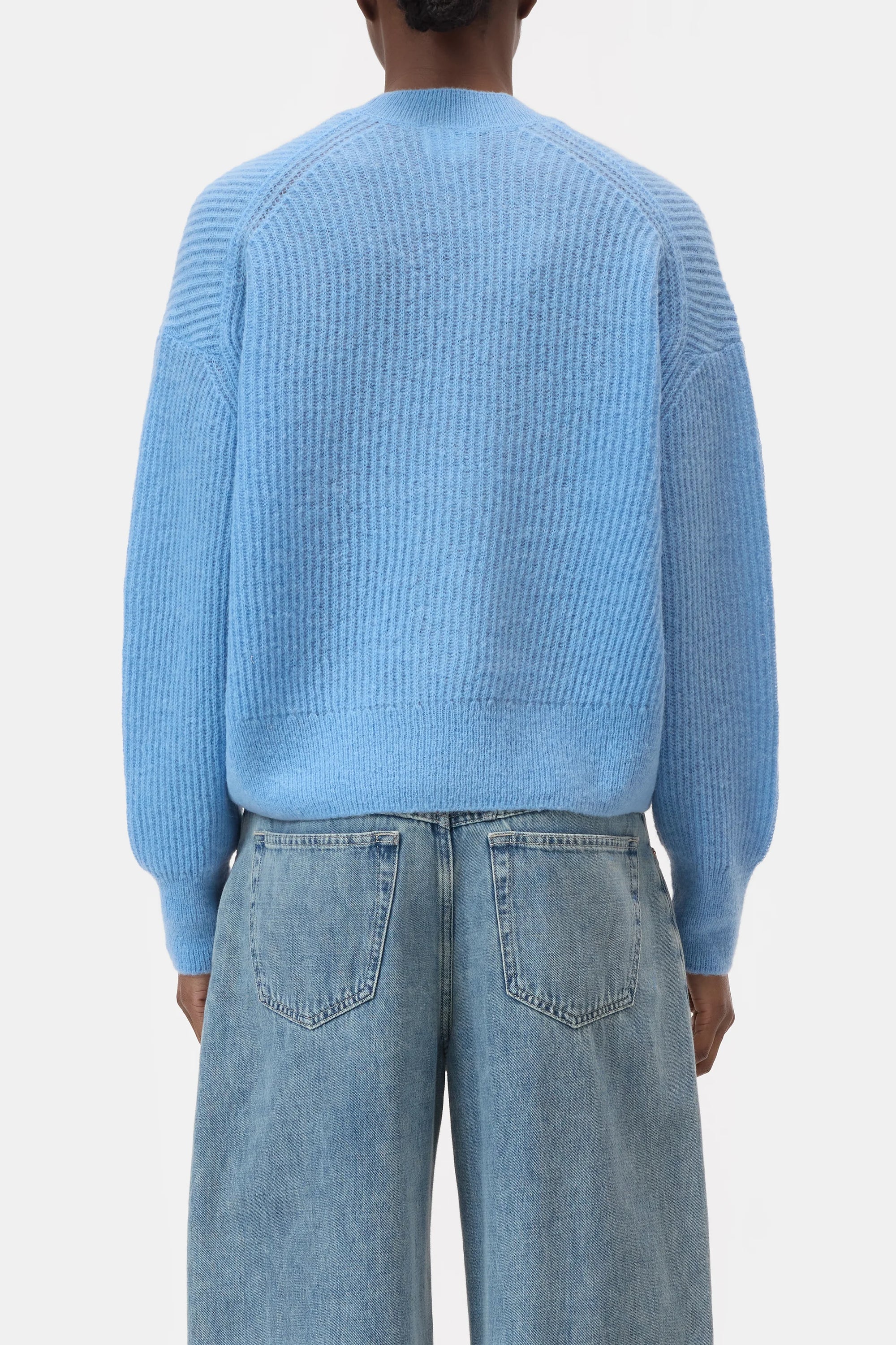 A person is seen from the back wearing the CLOSED V Neck Cardigan with a ribbed texture in light blue, paired with light blue denim jeans, set against a plain white background.
