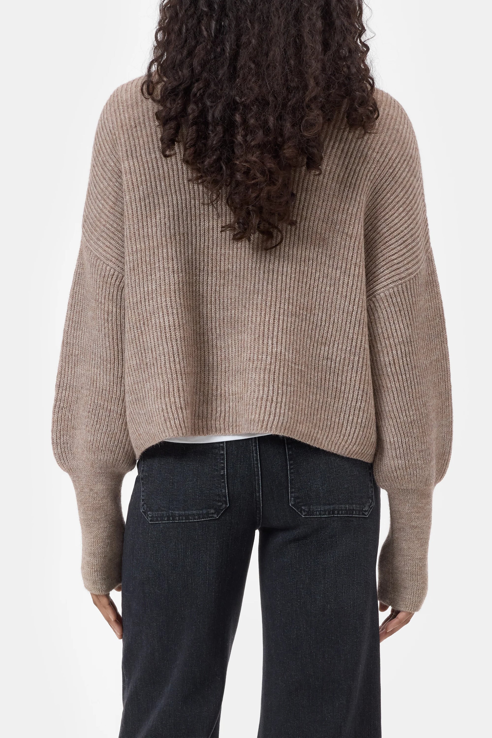 CLOSED funnel neck long sleeve jumper in dark color, back view, modeled with curly hair by Bungalow Furniture &amp; Accessories.