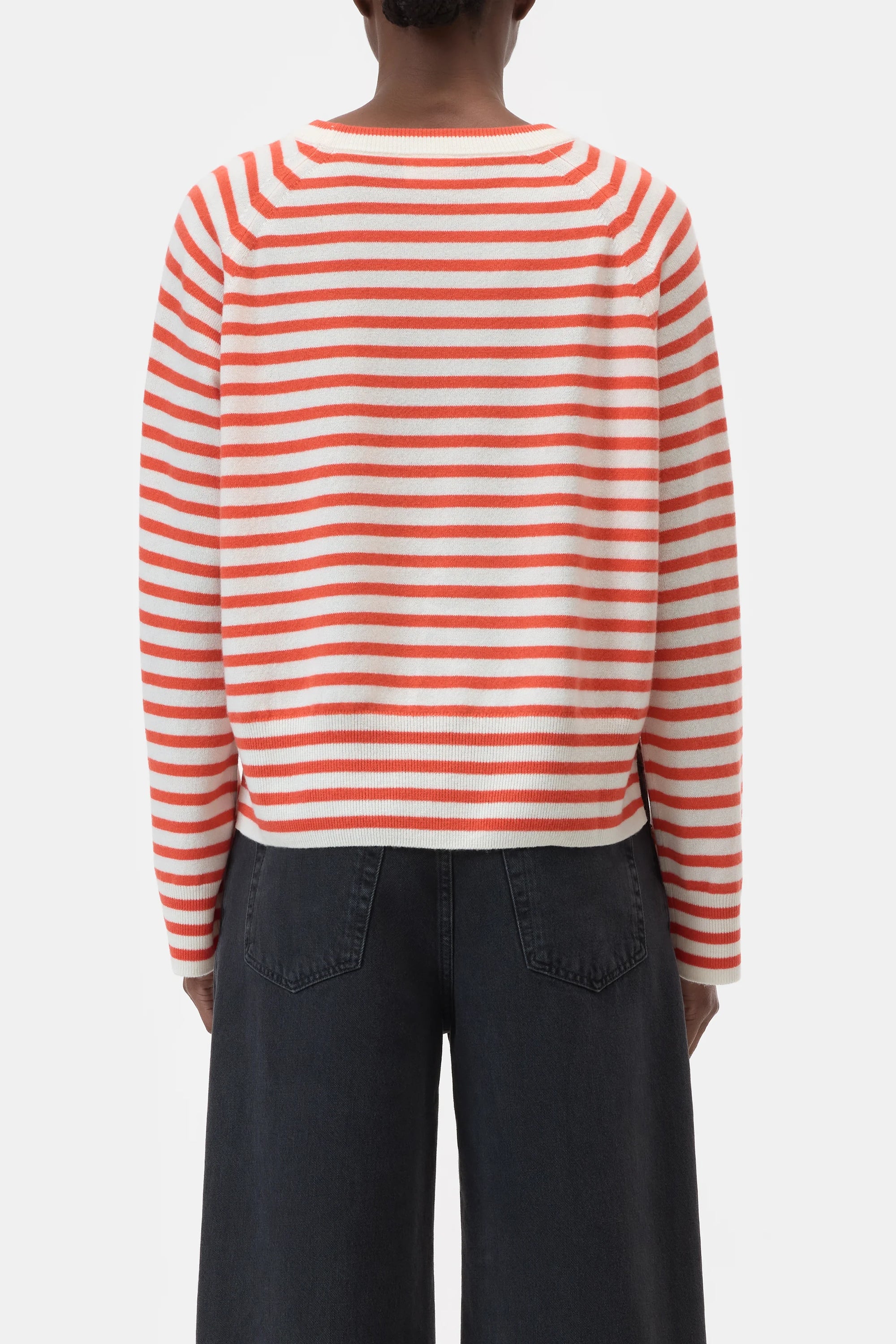 A person shown from the back against a plain white background wears CLOSED's Striped Crew Neck and high-waisted, wide-leg black jeans.