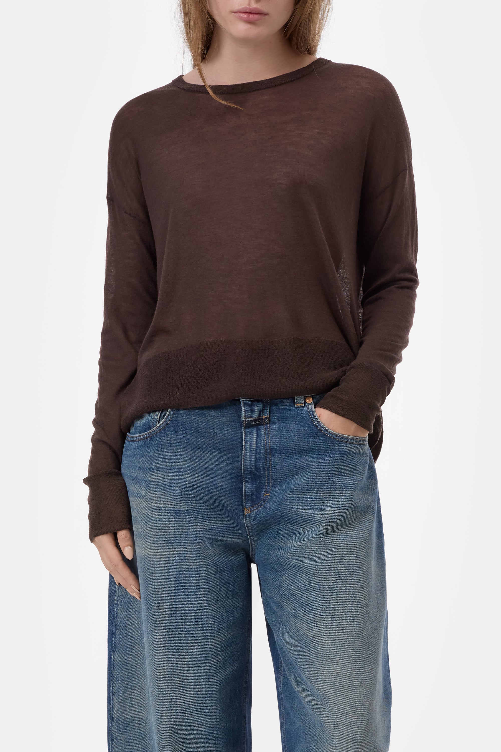 CLOSED crew neck long sleeve top in ivory with blue jeans, model standing against a white background.