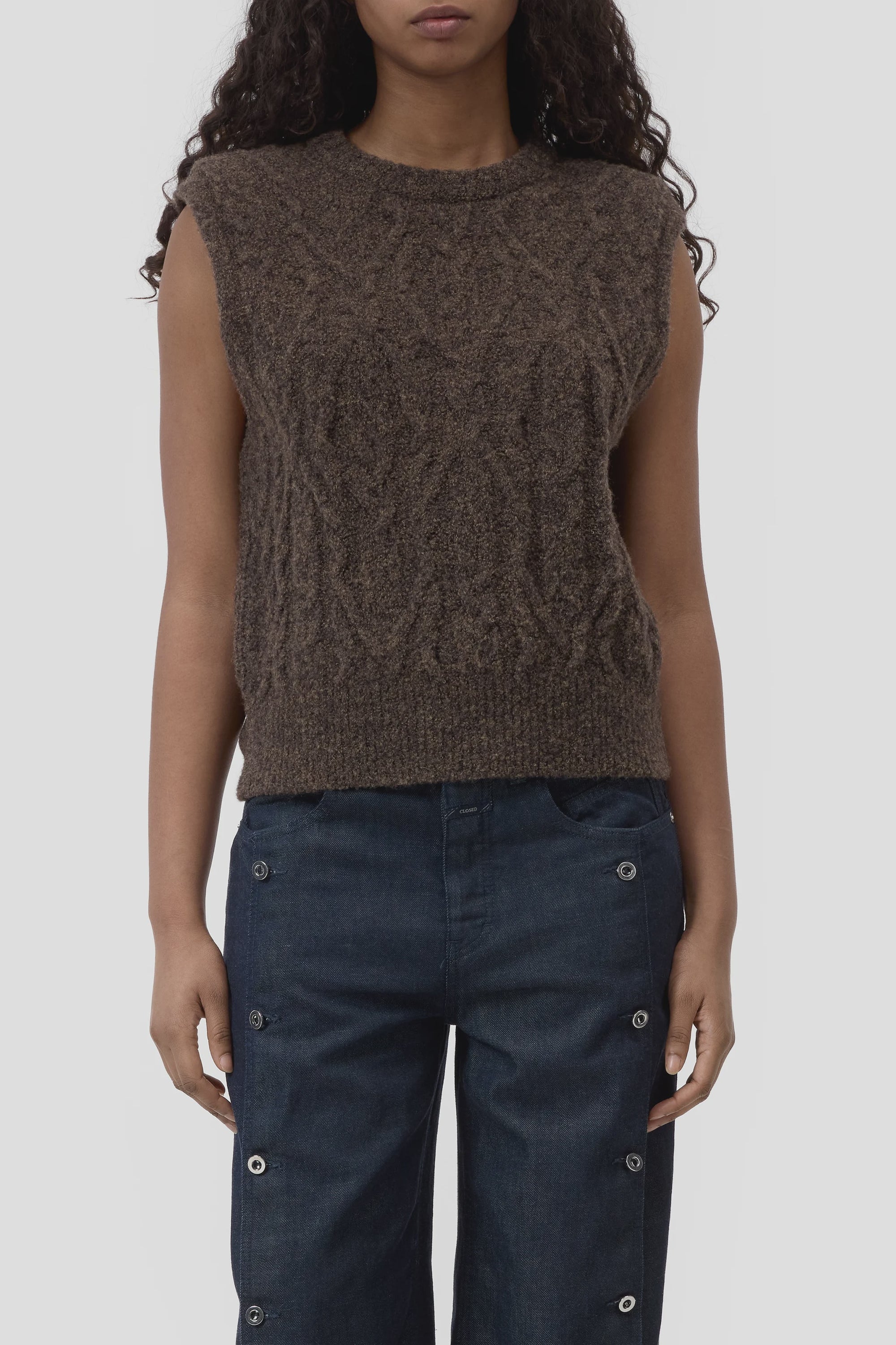 Brown CLOSED crew neck vest styled with high-rise dark jeans with metallic grommet accents from Bungalow Furniture.