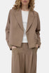 CLOSED cropped blazer in black over white top, model with hands in pockets, minimal studio background.