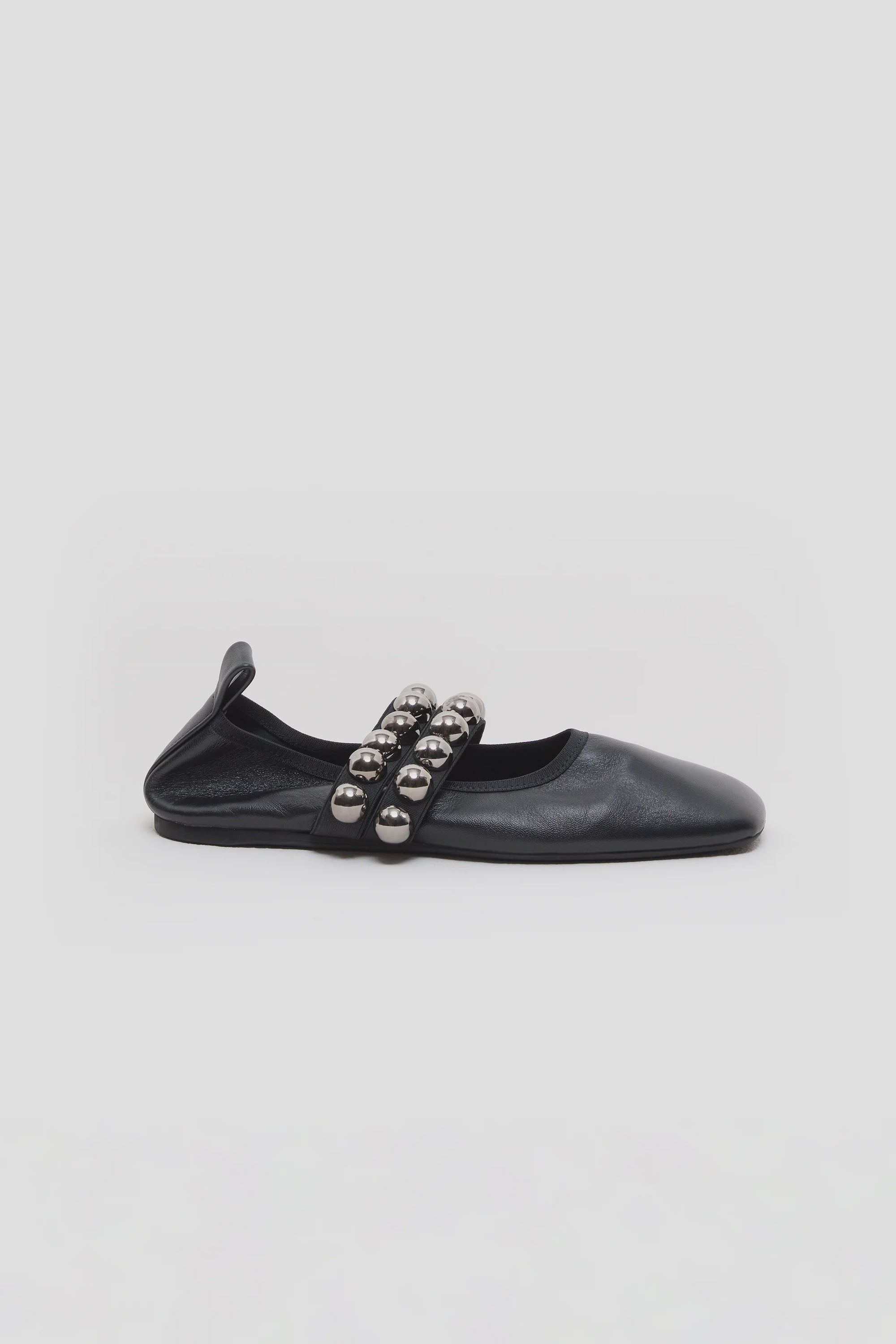The CLOSED Ballerina is a black leather flat with two top straps, each featuring large metallic silver beads. Expertly made in Italy, it offers timeless elegance. Shown against a white background.